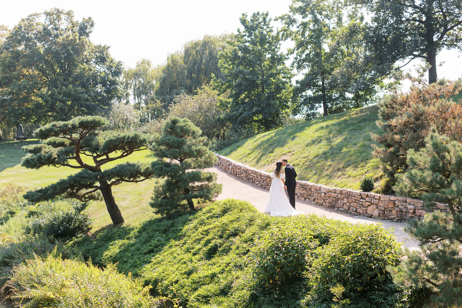 Newlyweds kissing in a landscaped garden at one of the best wedding venues in Chicago