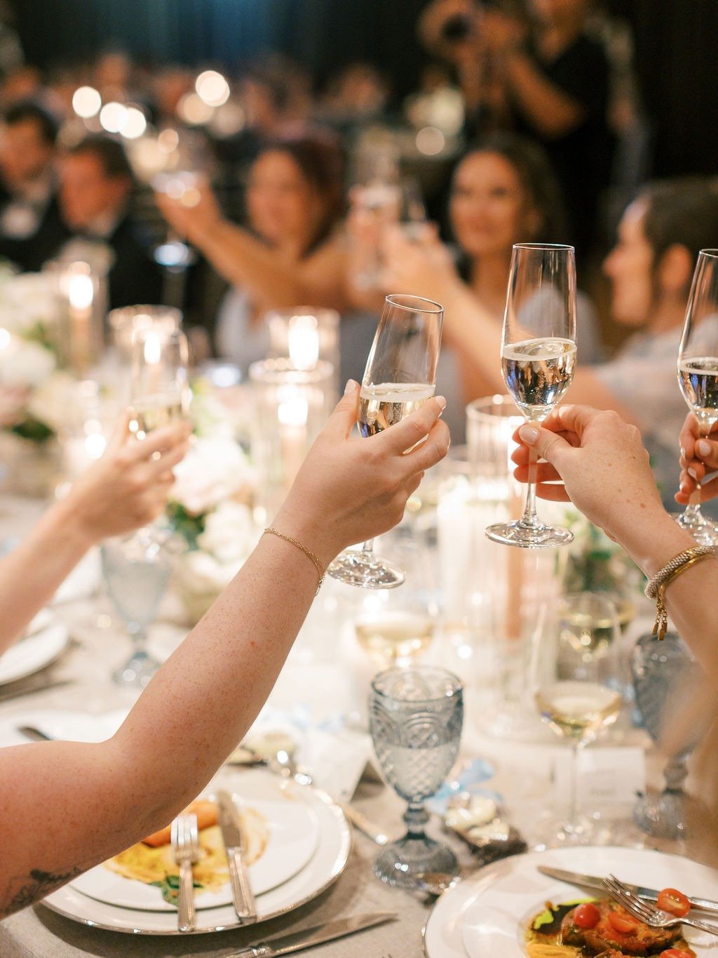 Guests raising champagne glasses during a reception that took place as a result of planning a wedding in Chicago