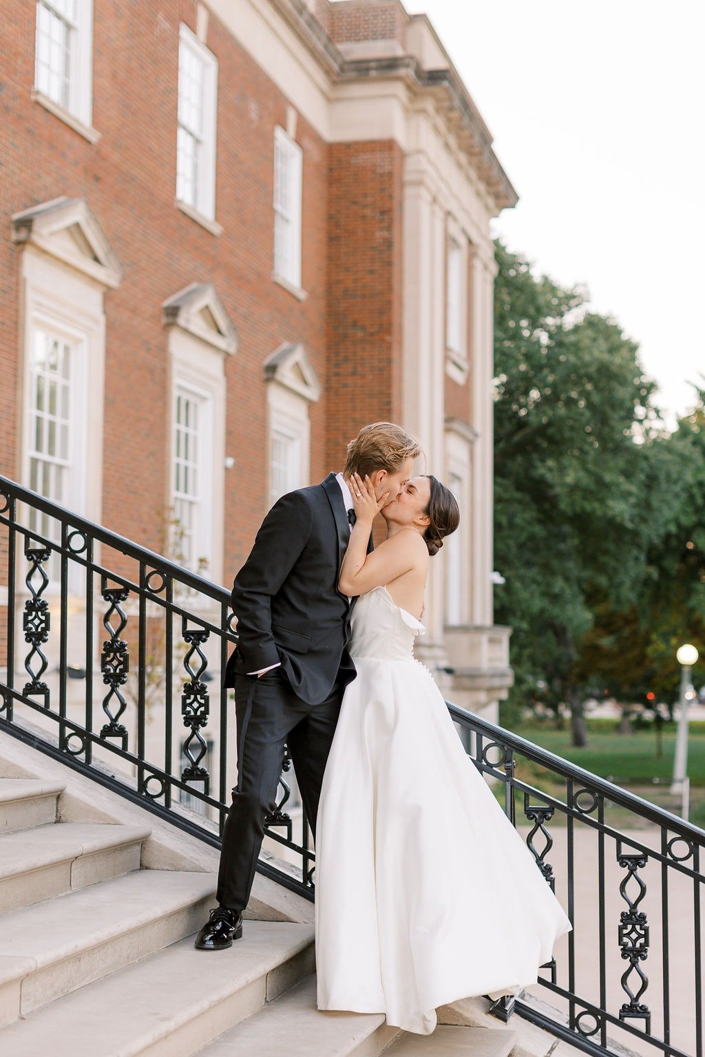 Bride and groom sharing a kiss on a staircase at one of the best places to get married in Chicago