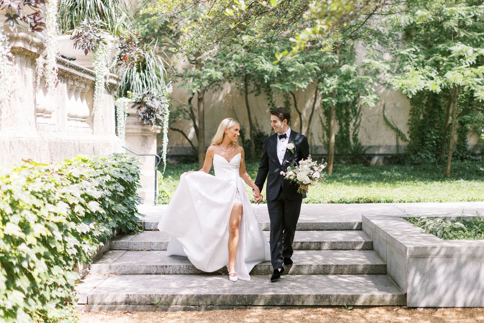 Bride and groom walking through a garden path after choosing to get married in Chicago