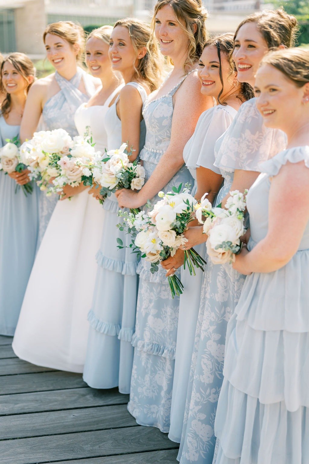 Bridesmaids holding bouquets and smiling outdoors during a wedding ceremony in Chicago