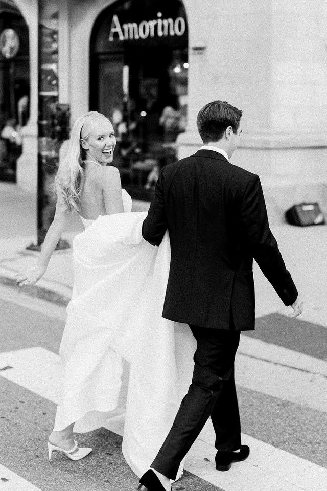 Bride and groom crossing a city street together after choosing to get married in Chicago