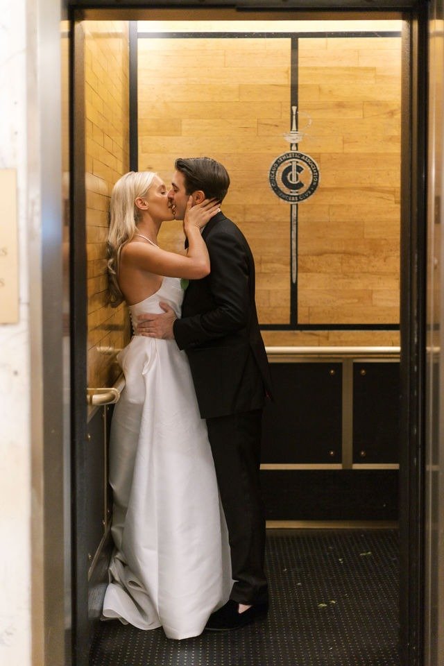 Bride and groom kissing inside an elevator after getting married in Chicago