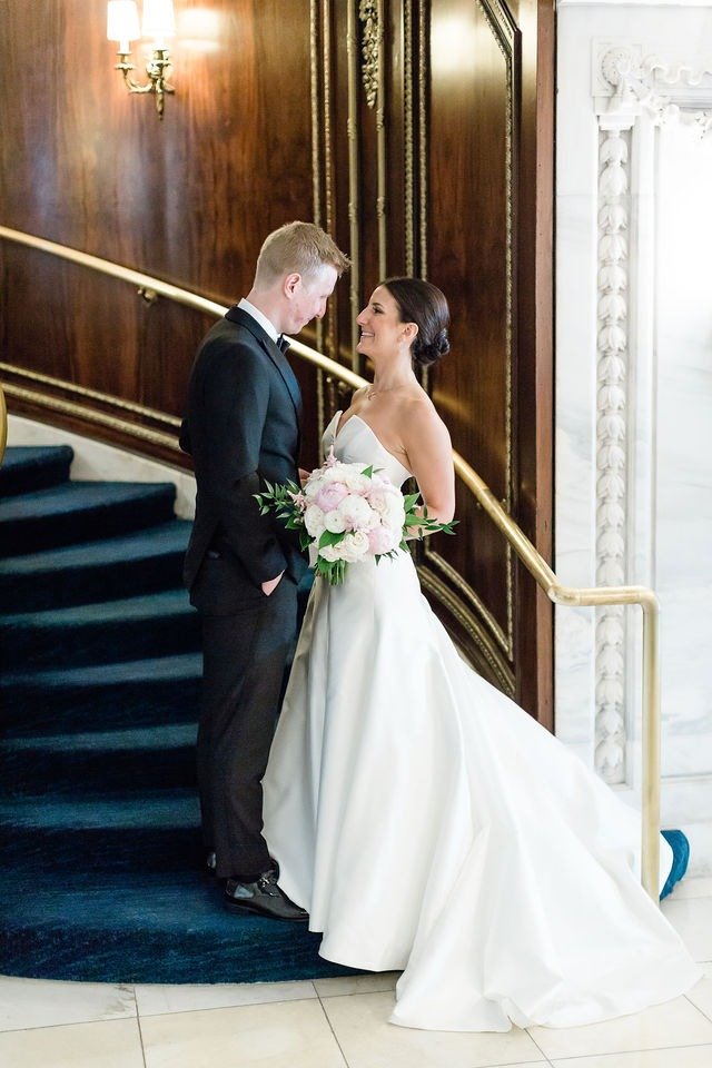 Elegant indoor portrait of bride and groom on staircase at one of the best places to get married in Chicago