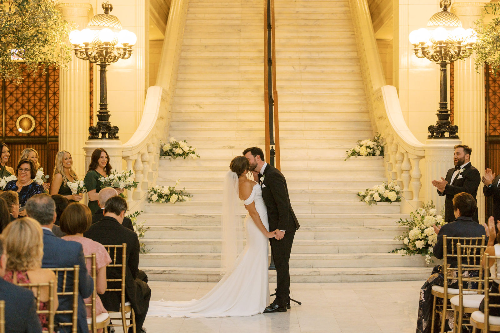 Couple sharing their first kiss during a grand indoor ceremony at a wedding reception venue in Chicago