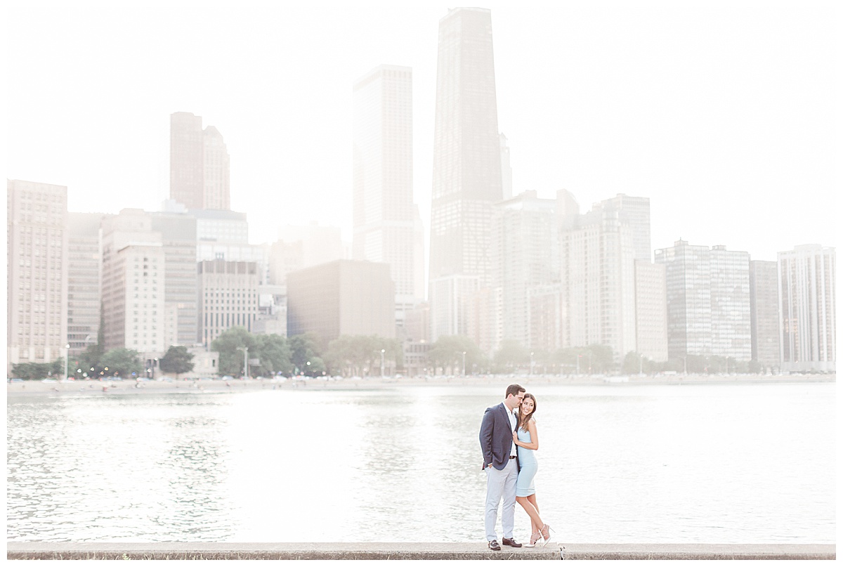 Couple standing in front of Chicago skyline at sunset