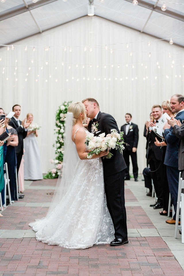 Couple sharing their first kiss down the aisle at one of the best wedding venues in Chicago