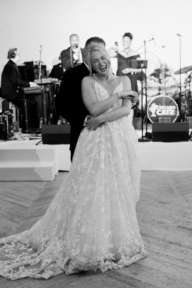 Bride laughing during a lively reception dance at a wedding reception venue in Chicago