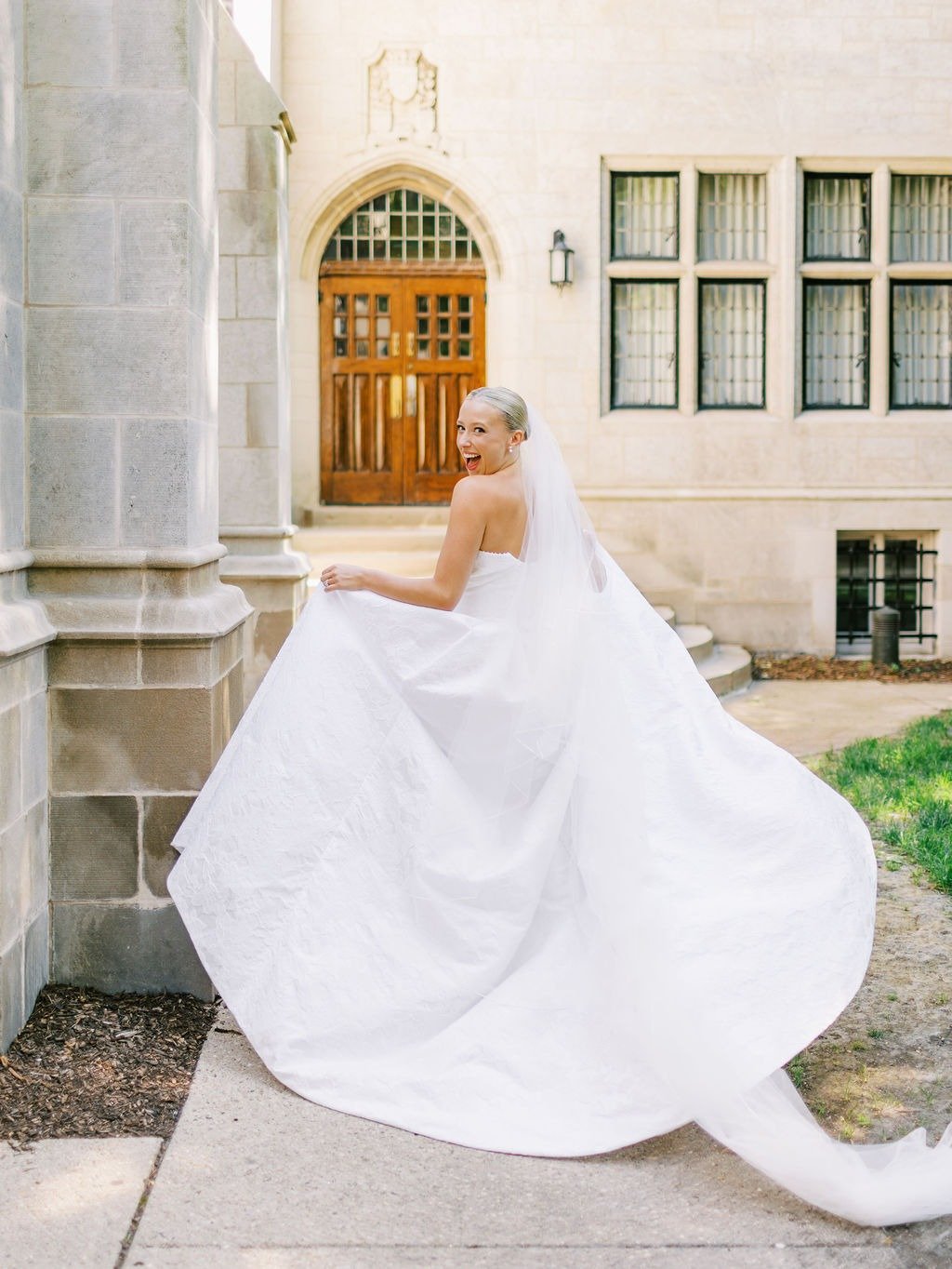 Bride twirling her gown outside a historic building at a wedding venue in downtown Chicago