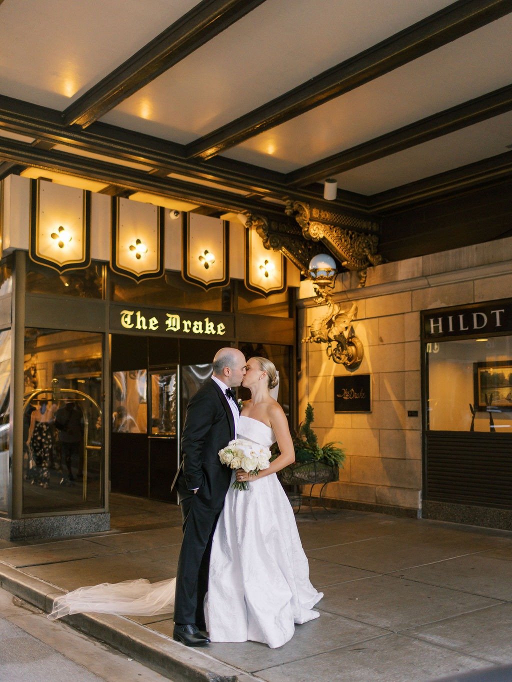 Couple kissing outside The Drake Hotel, a classic choice for wedding venues in Chicago