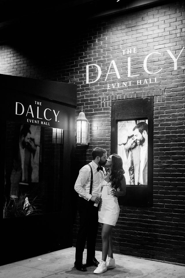 Couple sharing a kiss outside The Dalcy, a popular choice for wedding venues in Chicago suburbs