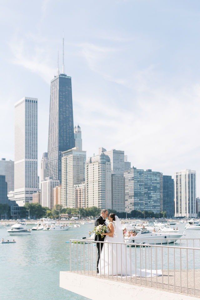 Couple embracing with the Chicago skyline backdrop at one of the best wedding venues in Chicago