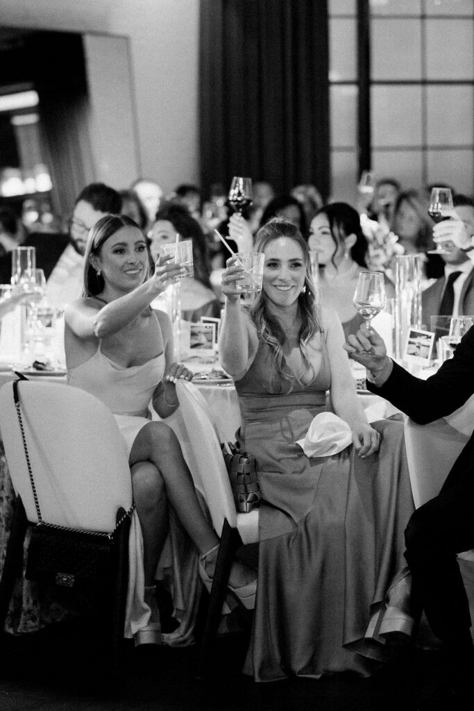 Wedding guests toasting during an elegant indoor reception at one of the best wedding places in Chicago