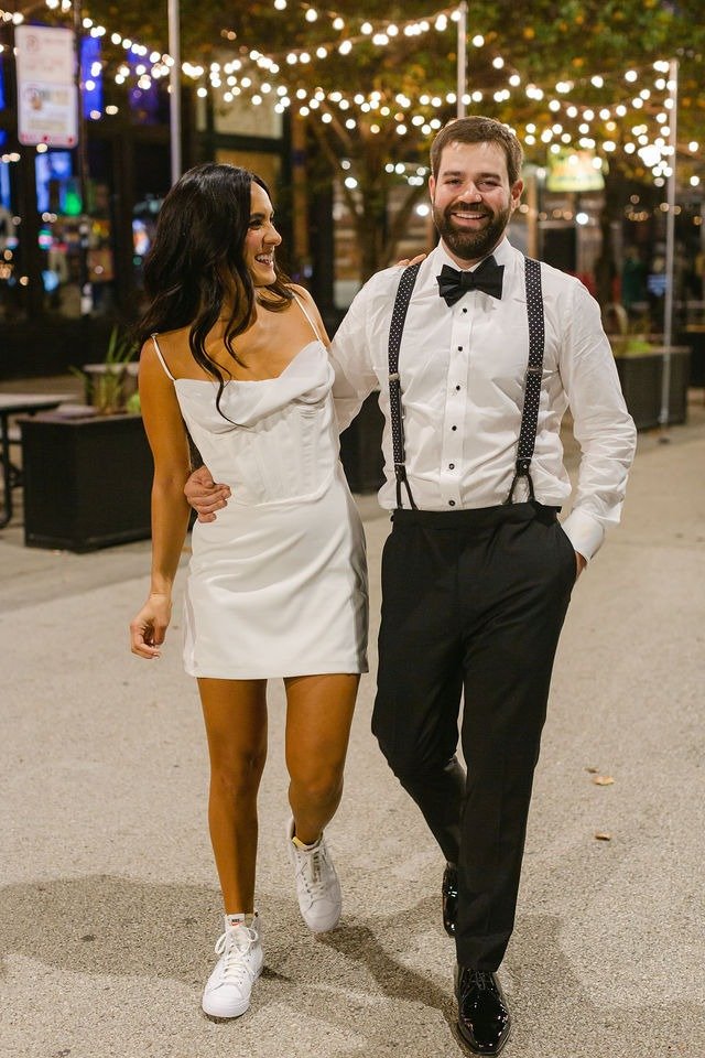 Newlyweds walking together at night in the city near wedding venues in downtown Chicago