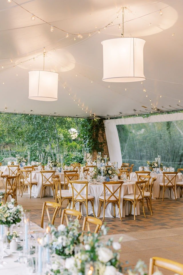 Reception tables set under a tent at a beautiful wedding venue in Chicago suburbs