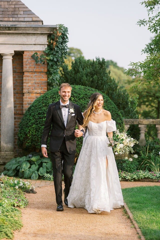 Bride and groom walking through a garden at a scenic wedding venue in Chicago suburbs