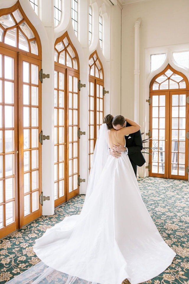 Bride and groom embracing in a sunlit hallway at one of the best wedding places in Chicago