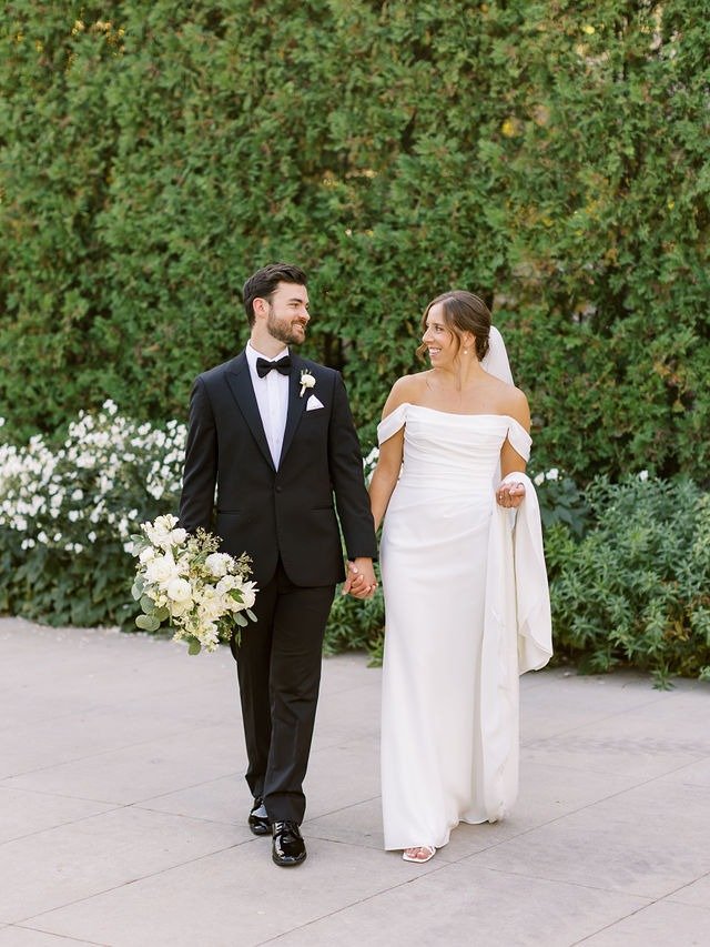 Bride and groom walking hand in hand outdoors at one of the best wedding venues in Chicago