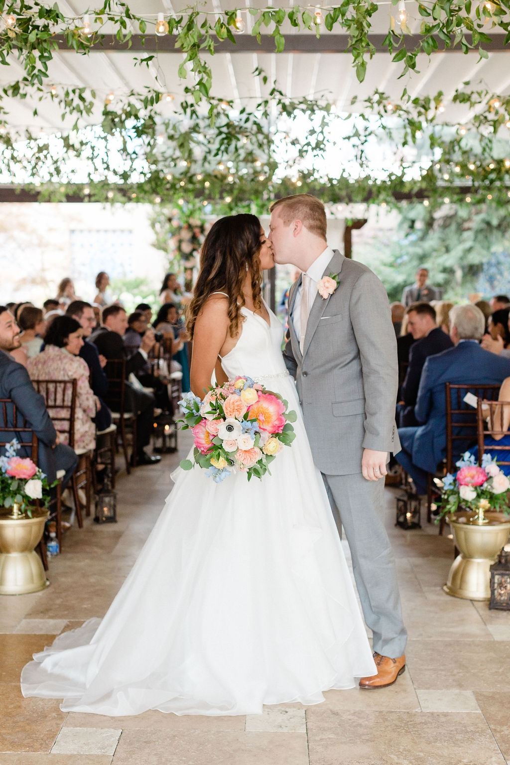 bride and groom sharing a kiss during their wedding ceremony at one of the top outdoor wedding venues in chicago
